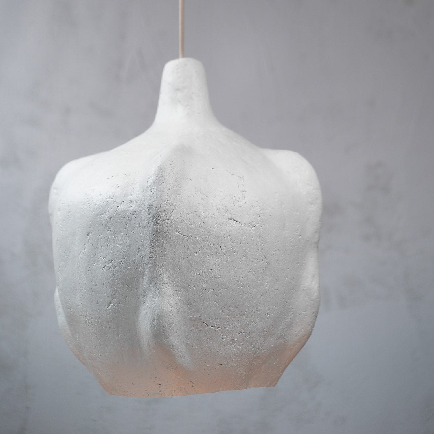 off white sculptural large pendant from paper mache with soft texture that looks like ceramic but is light weight
