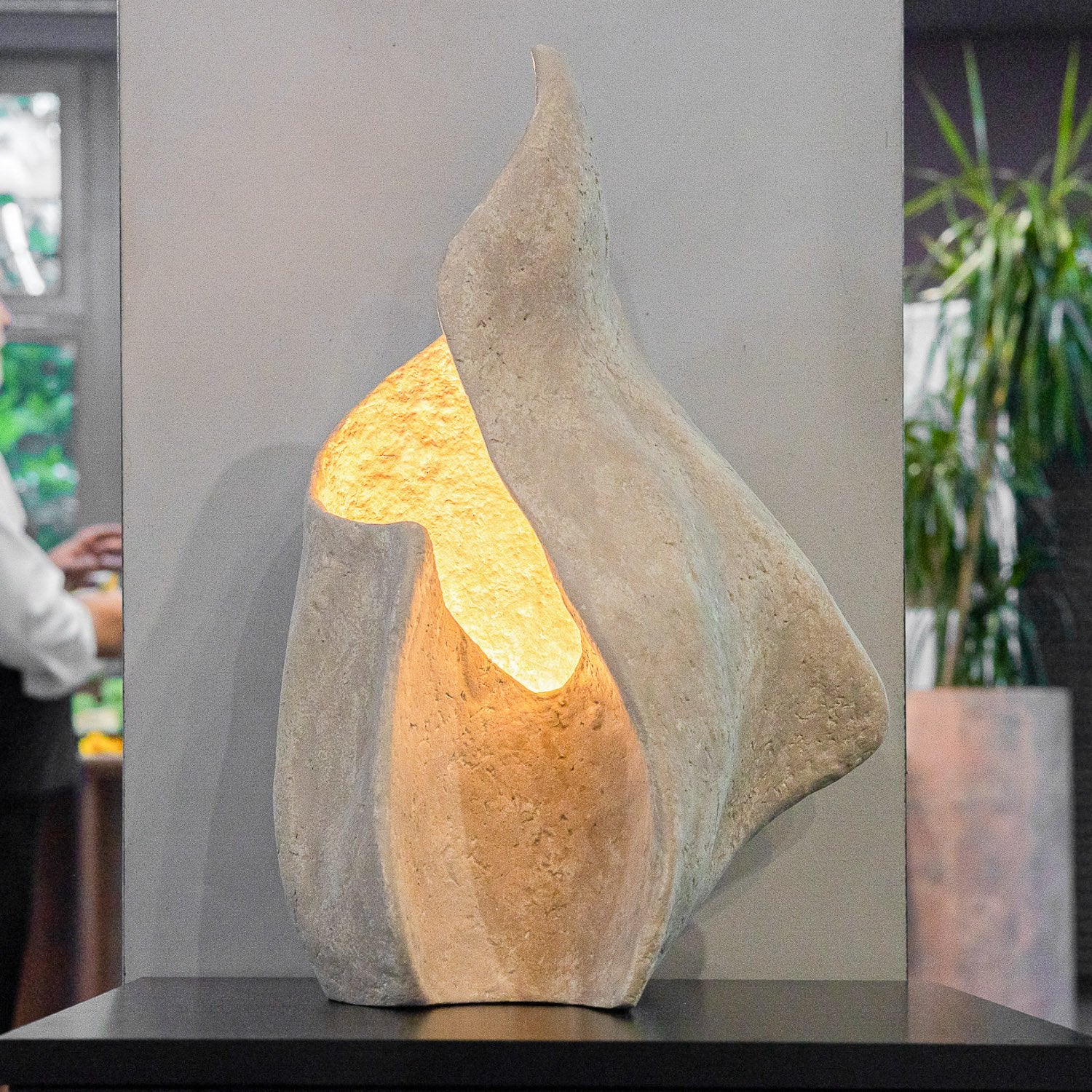 Decorative table lamp from paper mache with a beige limewash color effect on a table