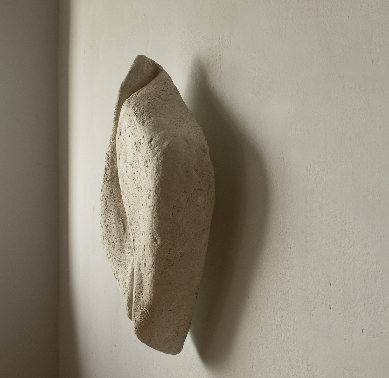 sculptural wall light for wabi sabi interiors on off white color made from soft paper mache