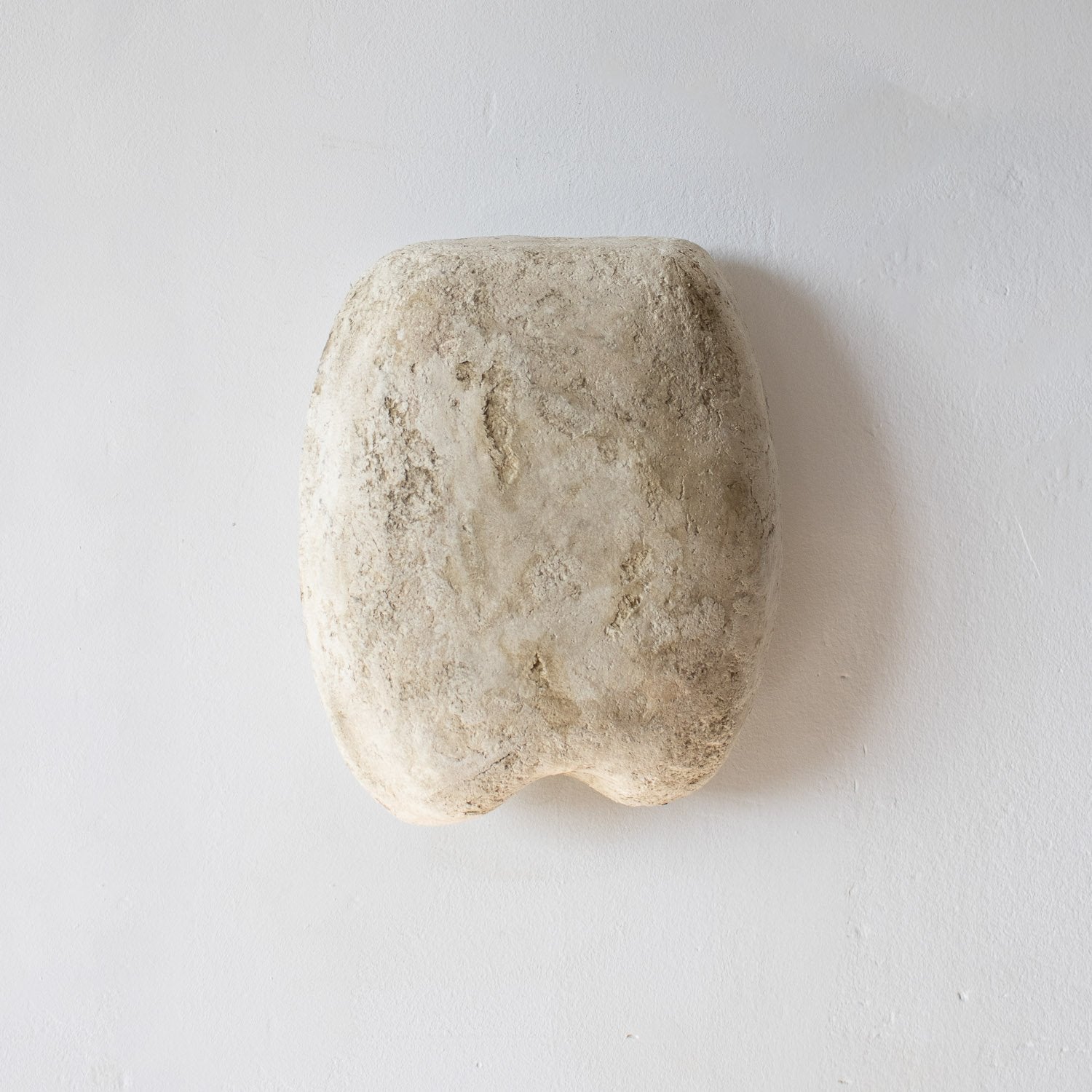 sculptural wall lamp from paper mache with a beige white color and stone effect
